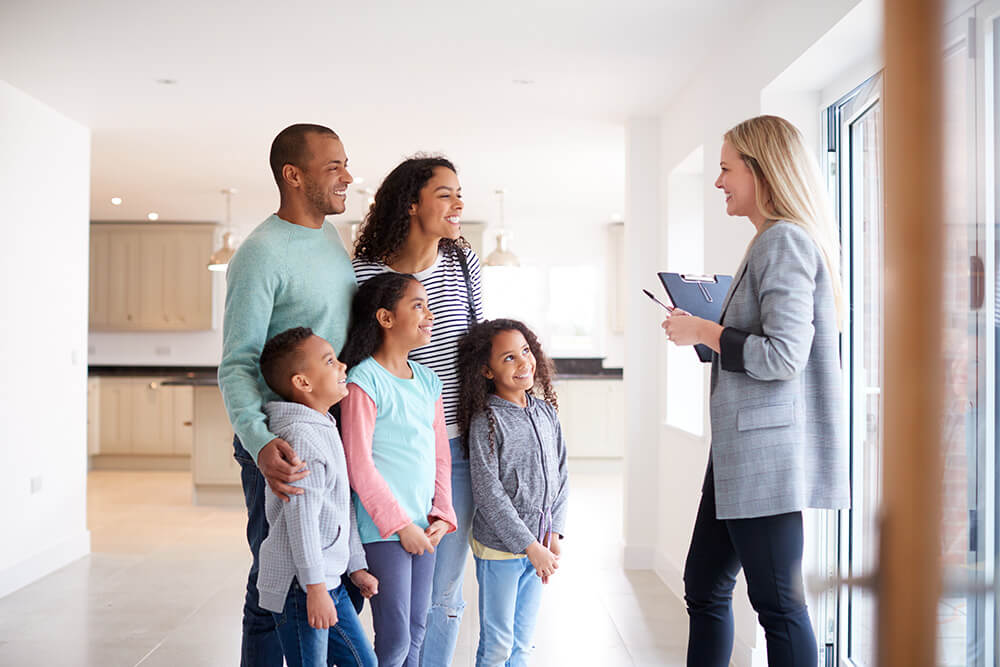 female-realtor-showing-family-interested-in-buying