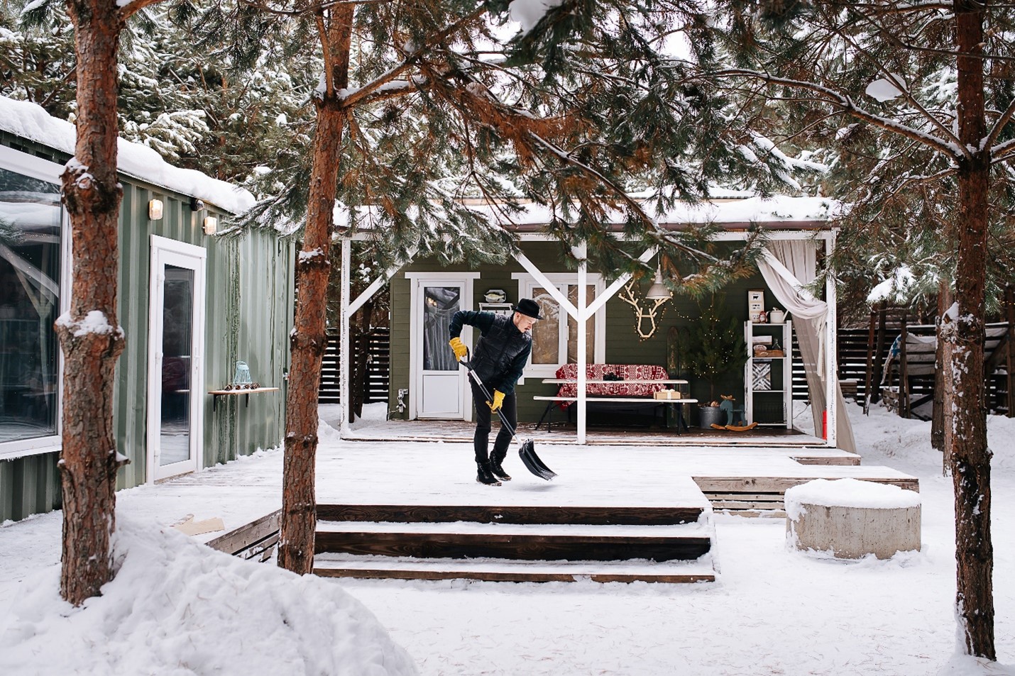 A photograph of a person shoveling their back deck's snow.