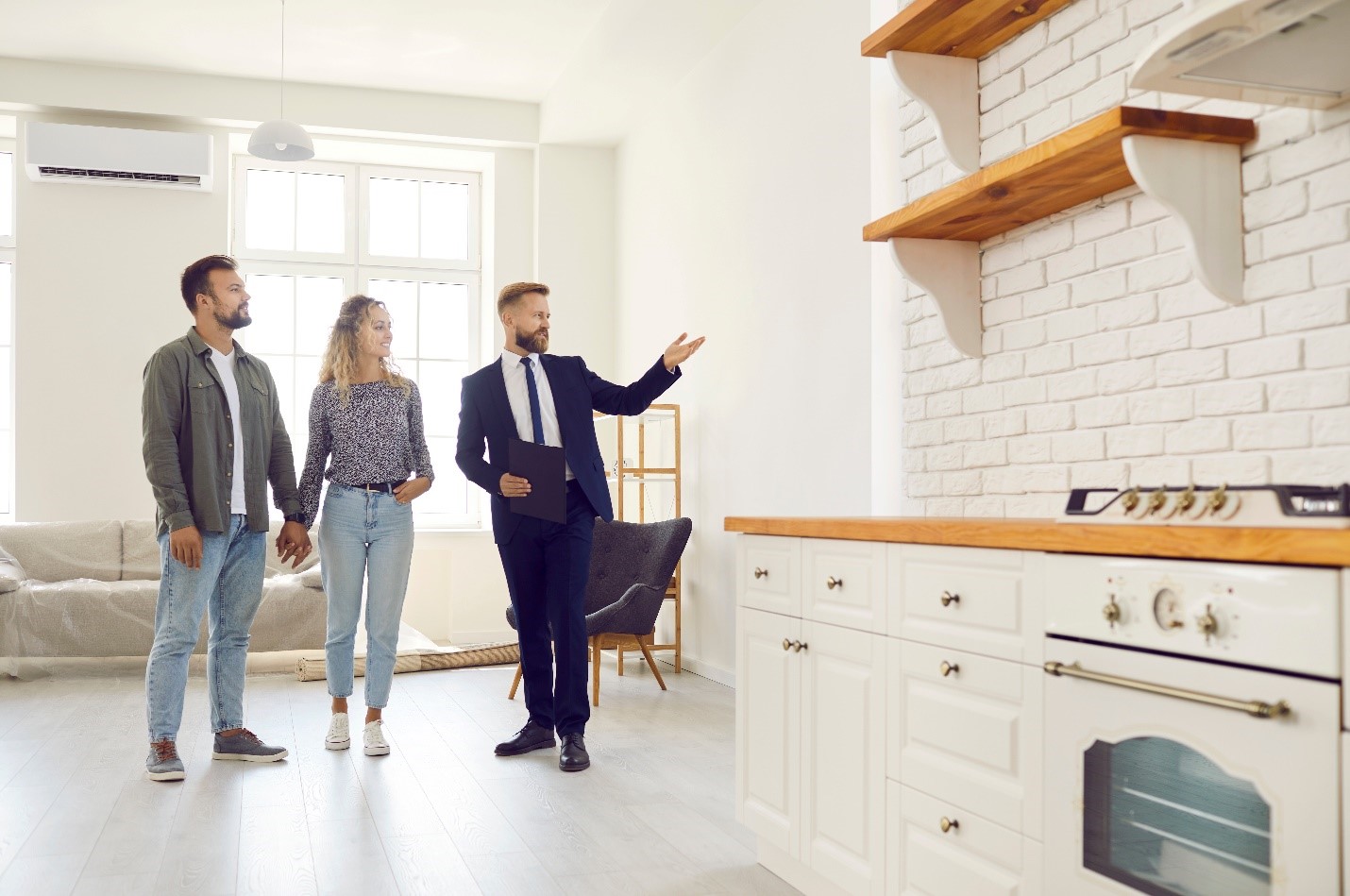 A Real Estate Agent showing a property to a couple.