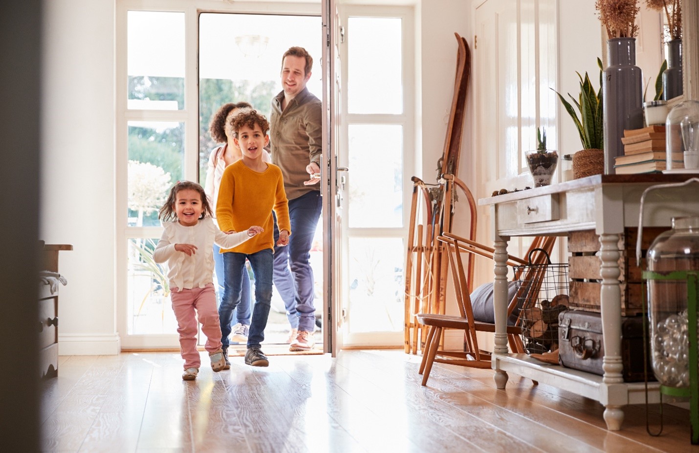 A young family running into their home.