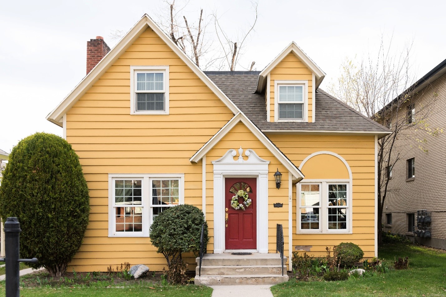 A bright yellow single family home.