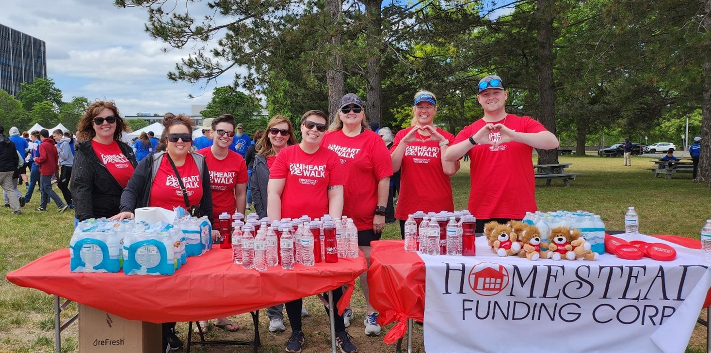 Homestead Funding employees at the 2023 Capital Region Heart Walk with a Homestead Funding table.
